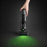 Guu Vision 2.0 cordless handheld vacuum using the green dust-reveal light to illuminate and target hidden dust on the floor.