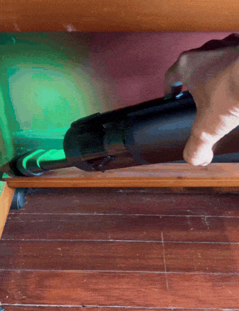 Guu Vision 2.0 reviews: Customer image showing how the green dust-reveal light exposes hidden dirt on baseboards for a thorough clean.