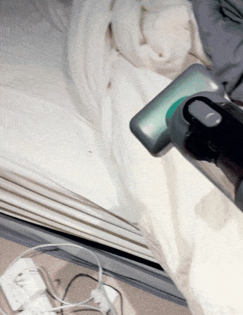 Guu Vision 2.0 reviews: Customer photo demonstrating the handheld vacuum safely and perfectly cleaning a bed without damaging the delicate fabric