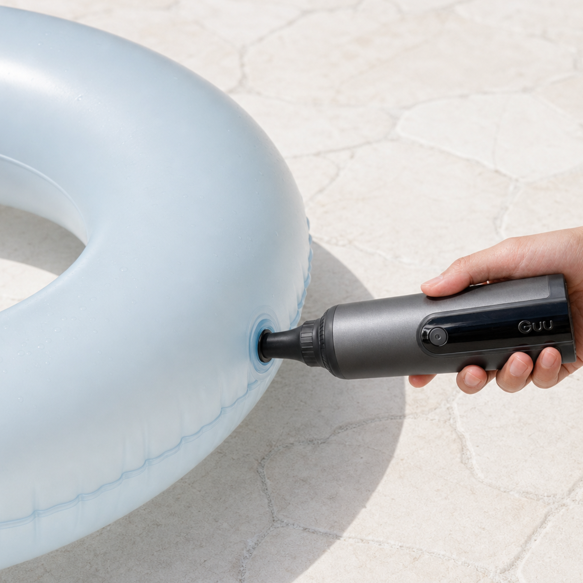 Guu Vision 2.0 portable vacuum acting as an air pump to quickly inflate a swimming ring, showcasing its versatile 4-in-1 design.